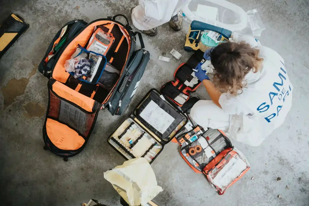Paramedic preparing emergency medical equipment and supplies